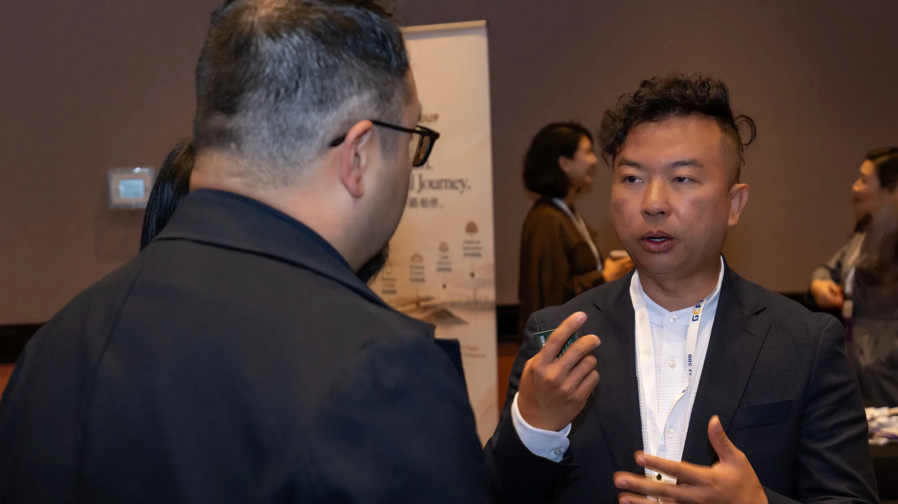 A Guaranti representative in conversation with an attendee