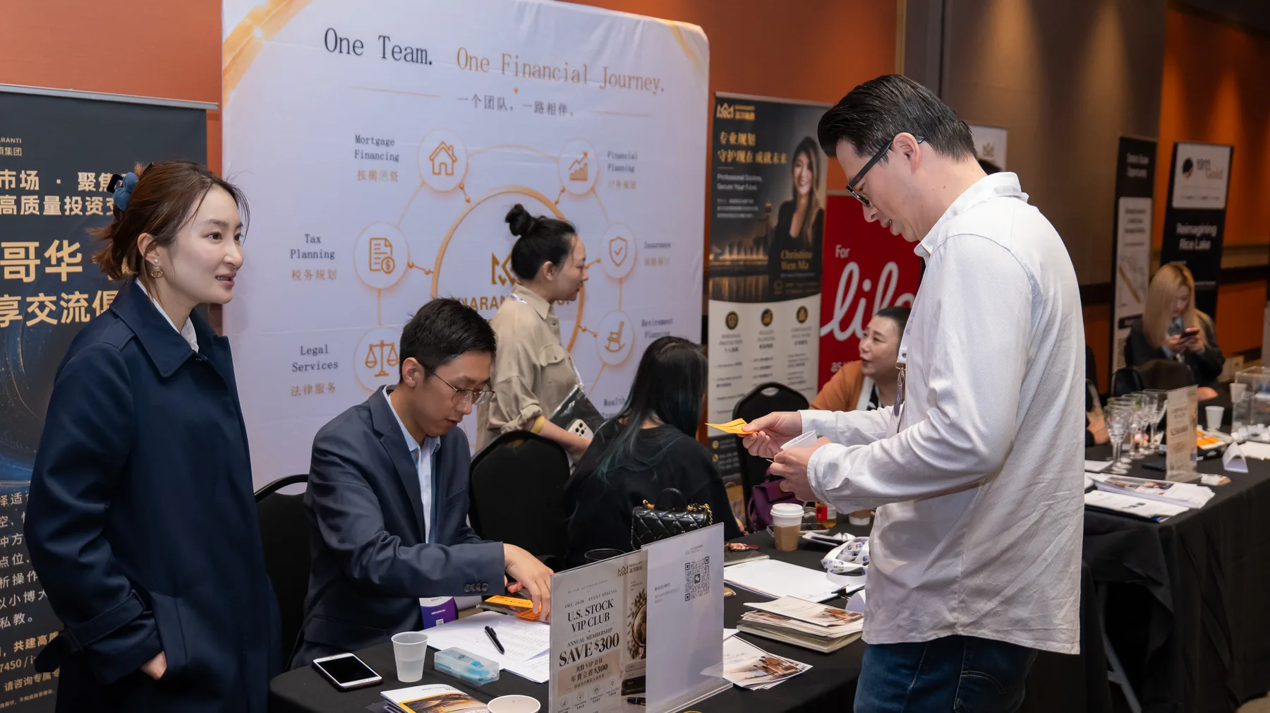 Guaranti team members reviewing information with visitors at the booth