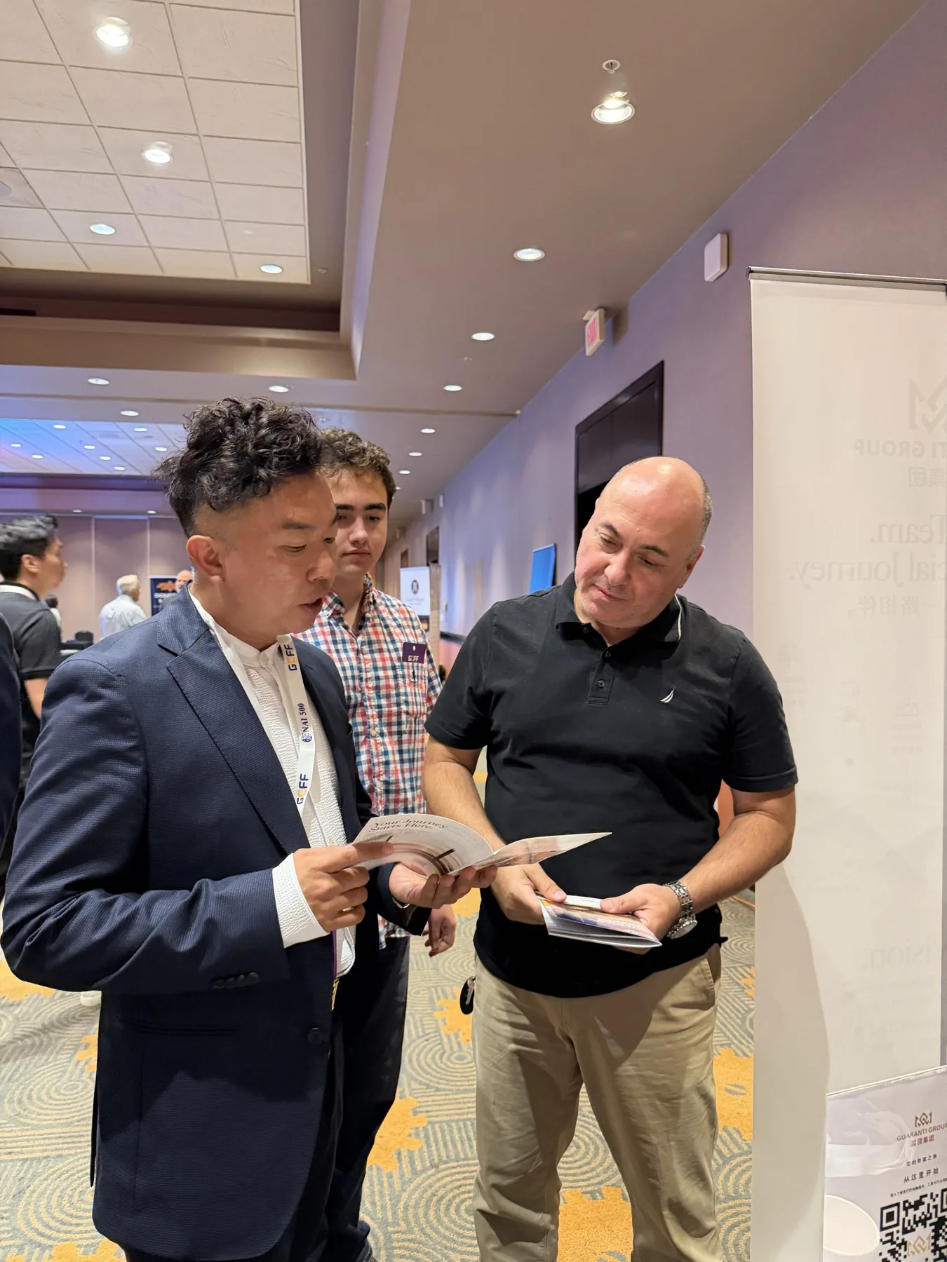 A Guaranti representative introducing professional service information to a visitor
