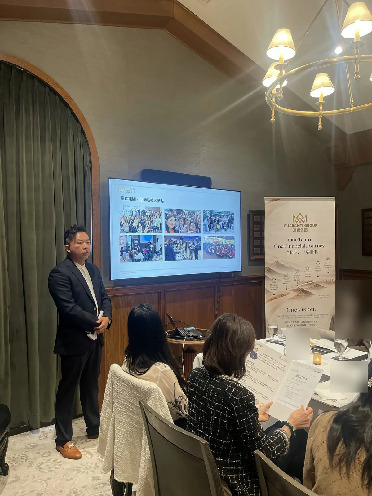 Elvis Hui opens the Private Wealth Briefing, with the room and Guaranti branding visible; some details have been blurred for privacy