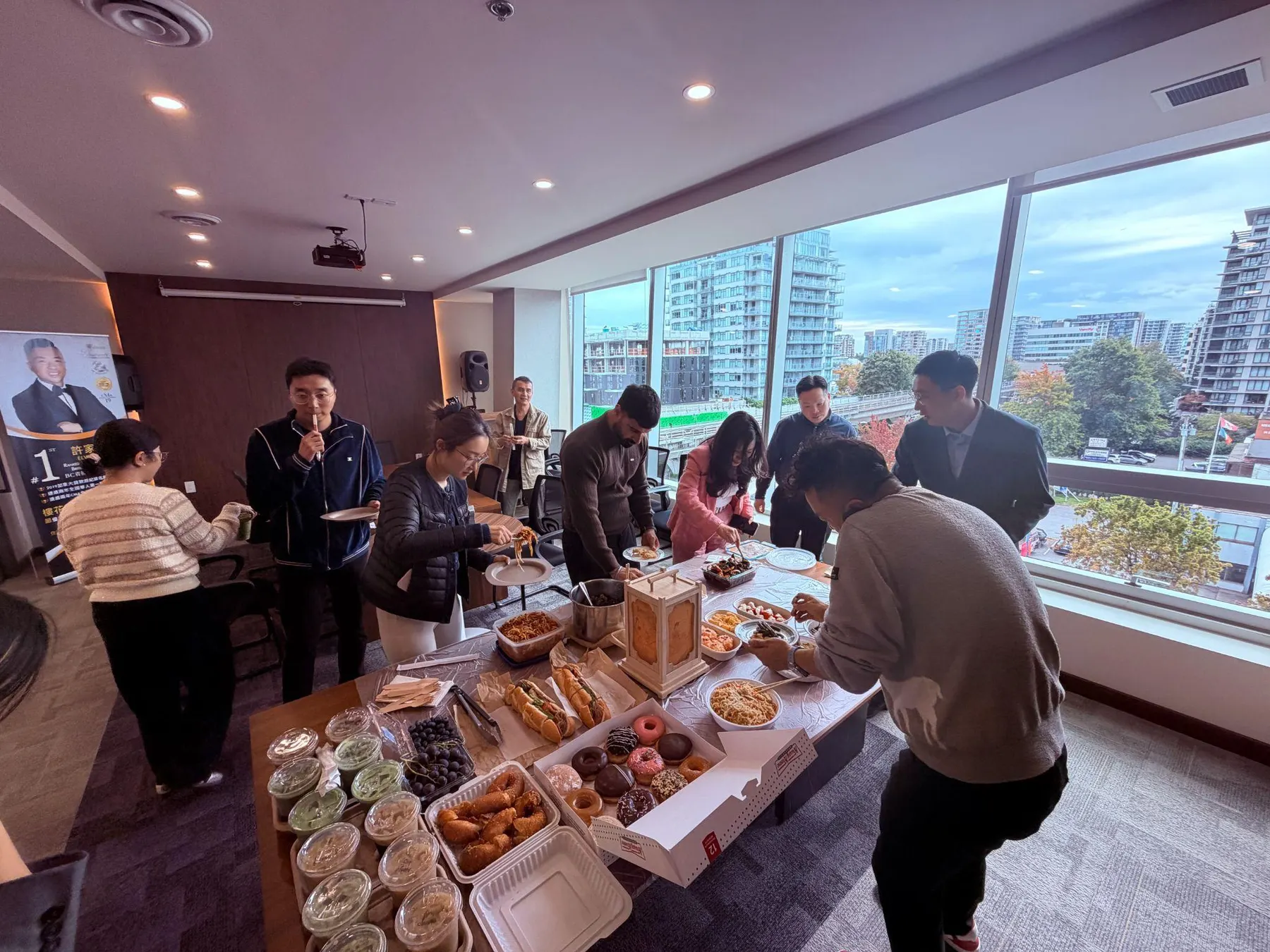 Team members gathering around the shared food